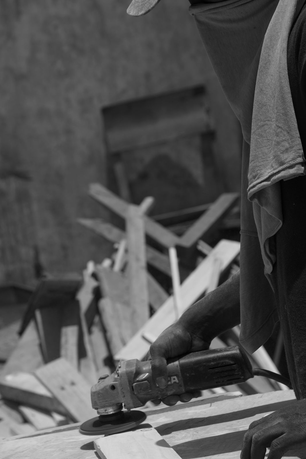 A carpenter cutting timber with an angle grinder